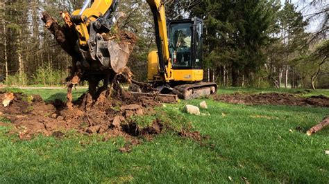 mini excavator pulling stumps|mini excavator stump removal.